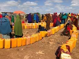 Women queuing for water distribution